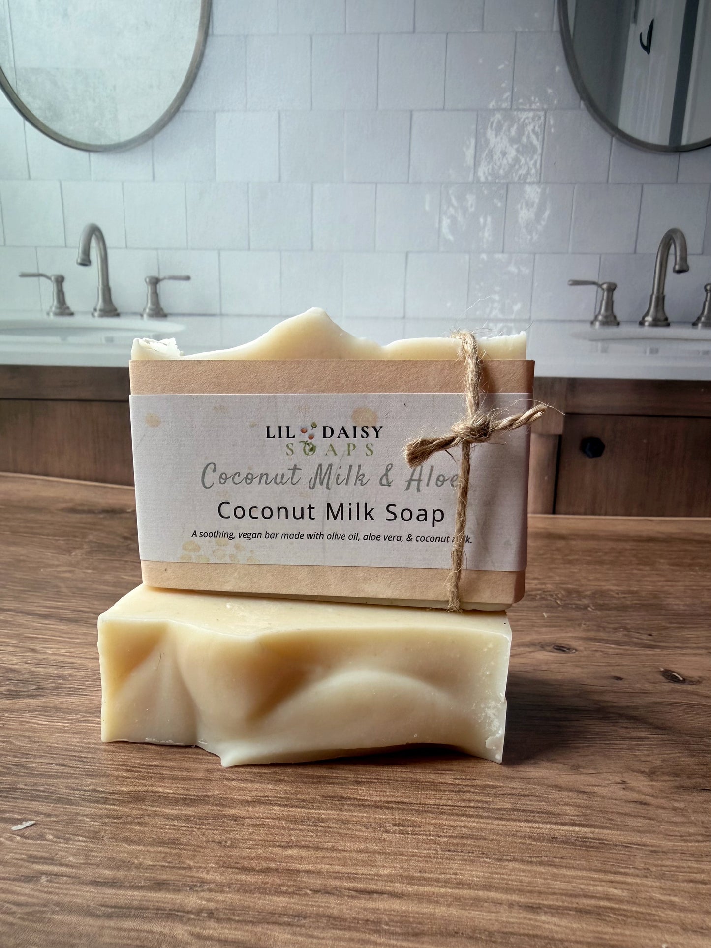 Two Lil Daisy Soaps Unscented Coconut Milk & Aloe Bars stacked on a counter—great for sensitive skin.