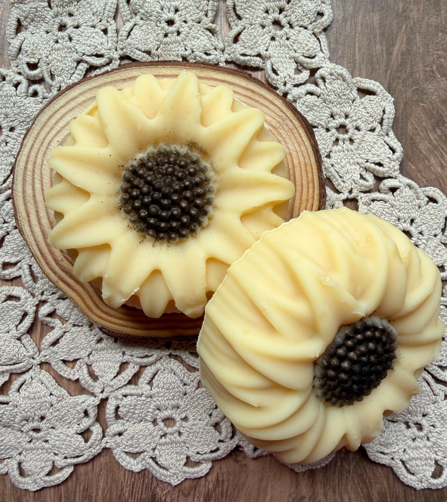 The Sunflower Goat Milk Soap Gift Set by Lil Daisy Soaps sits atop a wood slice, perfect for gifting.