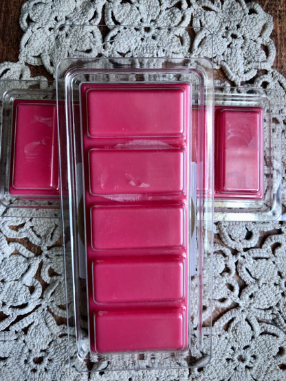 A Lil Daisy Soaps Apple Orchard Snap Bar Wax Melt sits on a lace-patterned tablecloth.