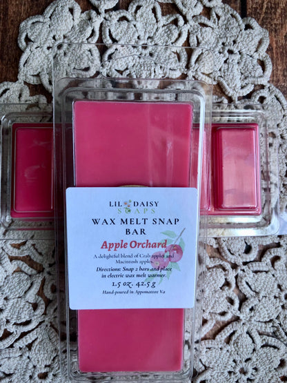 A pink Apple Orchard Snap Bar Wax Melt by Lil Daisy Soaps rests on a doily, evoking cozy fall vibes.