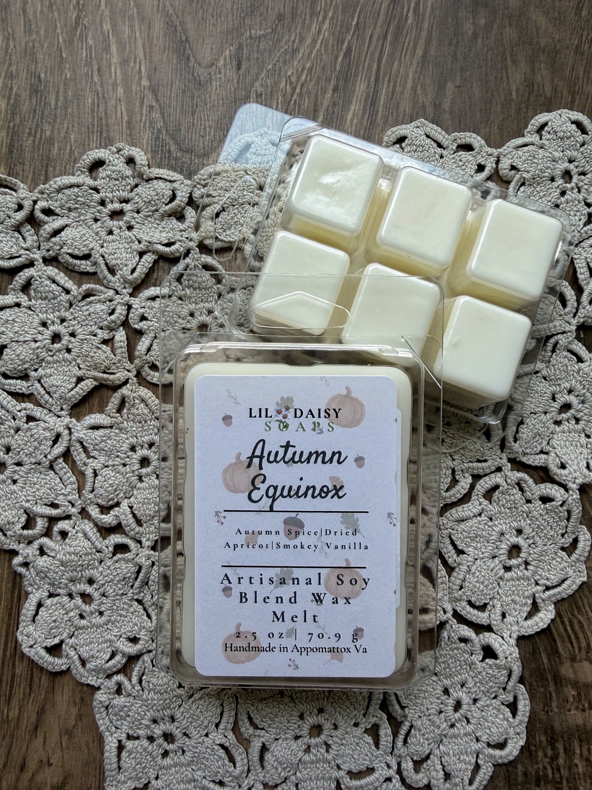 Two Autumn Equinox soy wax melts by Lil Daisy Soaps on lace and wood, handmade in Virginia.