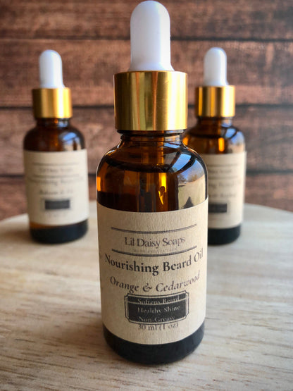 Lil Daisy Soaps Beard Oil in amber glass dropper bottles for beard conditioning on a wooden surface.