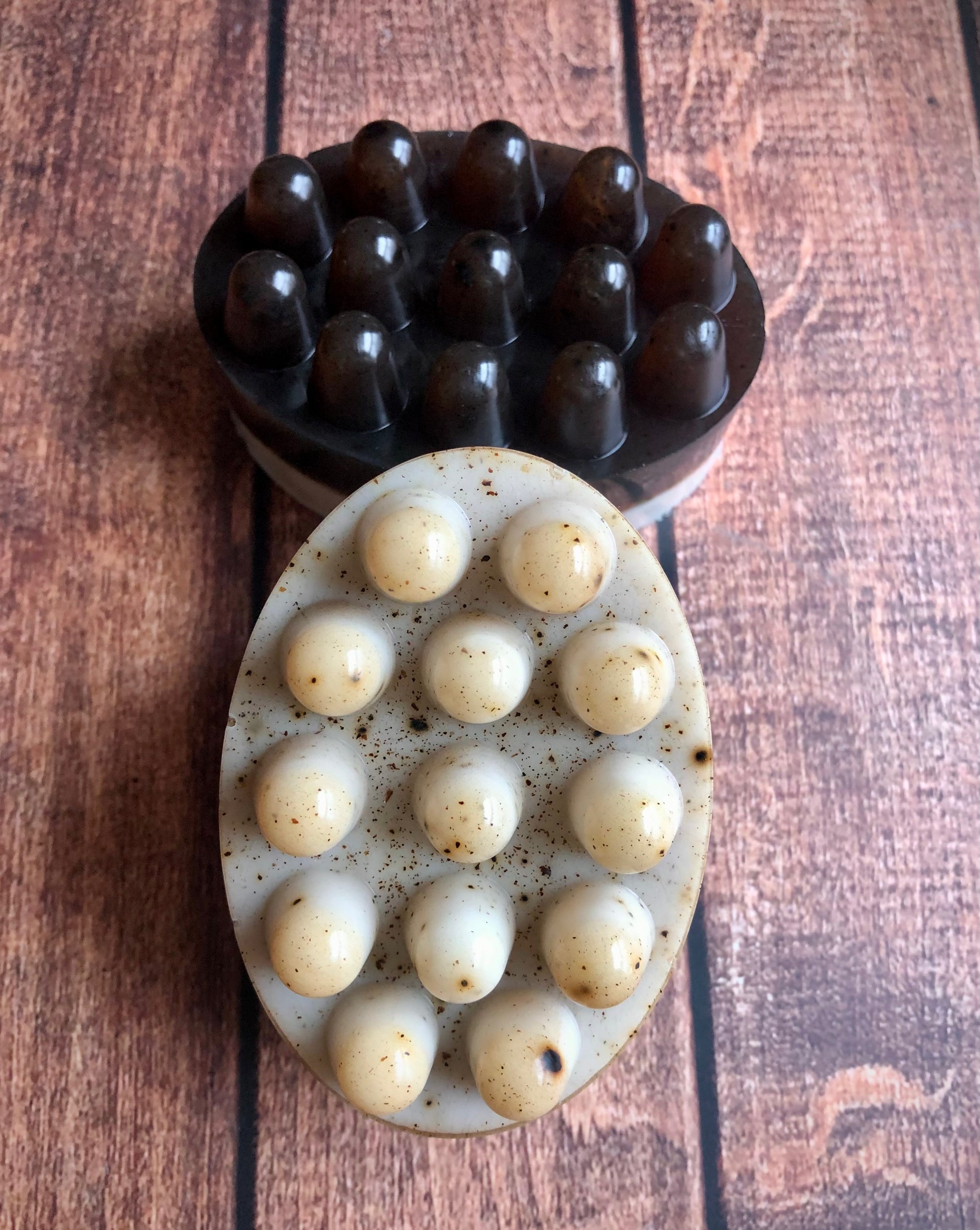 Lil Daisy Soaps Coffee & Cream Massage Soap Bars, dark brown and white with specks, rest on a wood surface.