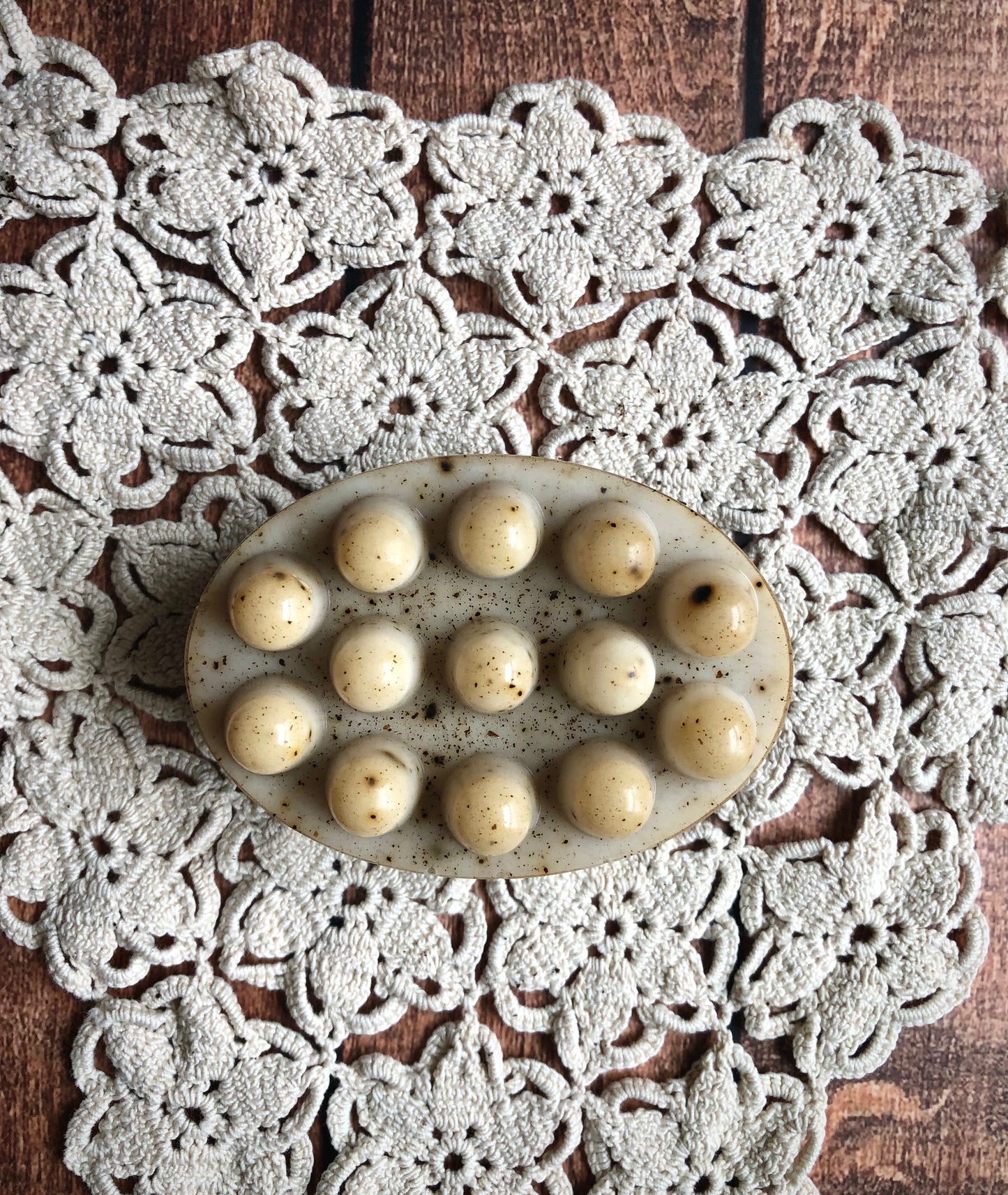 Lil Daisy Soaps Coffee & Cream Massage Soap Bar with raised bumps on a white crochet doily on wood.