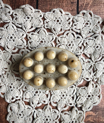 Lil Daisy Soaps Coffee & Cream Massage Soap Bar with raised bumps on a white crochet doily on wood.