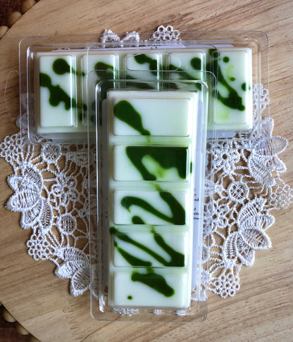 Two Daisy Fields Wax Melt Snap Bars by Lil Daisy Soaps rest on a lace doily and wooden surface.