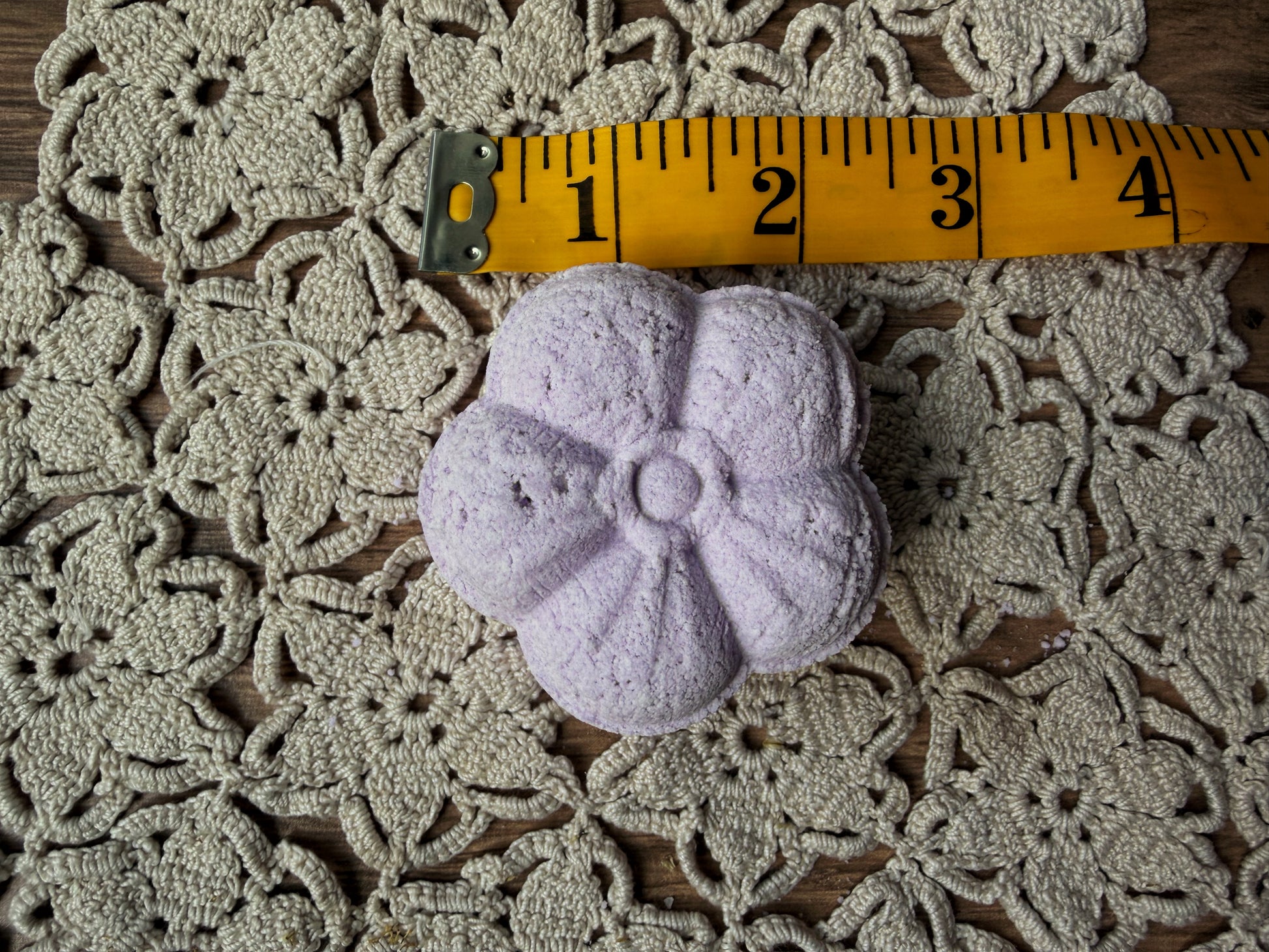 Lil Daisy Soaps’ Essential Oil Shower Steamer, 2″ wide, flower shaped—perfect for aromatherapy relaxation.