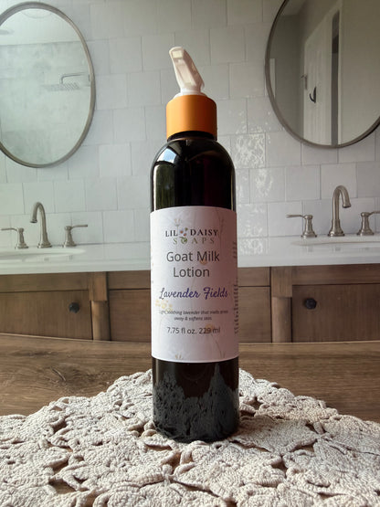 Lil Daisy Soaps Goat Milk Lotion sits on a doily in a double-sink bathroom with mirrors.