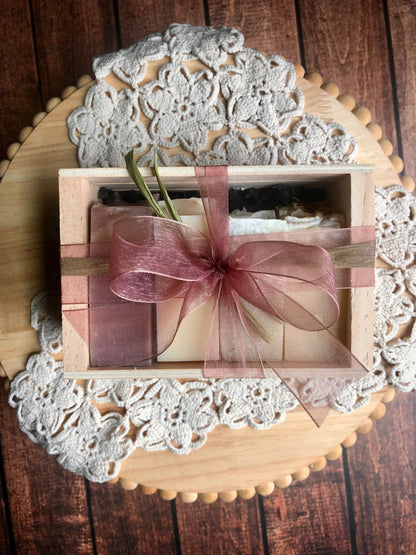 Goat Milk Soap Sample Set by Lil Daisy Soaps in a wooden box with pink ribbon, set on a rustic background.