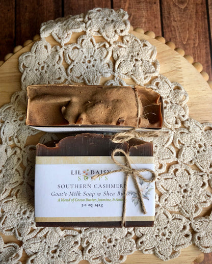 Lil Daisy Soaps’ Southern Cashmere Goat Milk Soap in a box on lace doily and wooden surface.