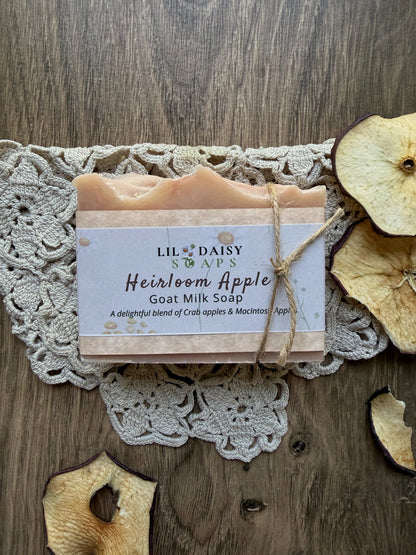 Lil Daisy Soaps Heirloom Apple Goat Milk Soap with creamy lather, shown on lace with dried apple slices.