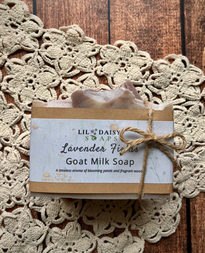 Lavender Fields Natural Goat Milk Soap Bar by Lil Daisy Soaps, tied with twine on a crocheted mat.