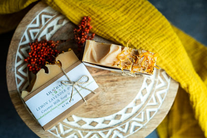Lemon & Lavender Natural Goat Milk Soap Bar by Lil Daisy Soaps on a tray with orange berries and yellow cloth.
