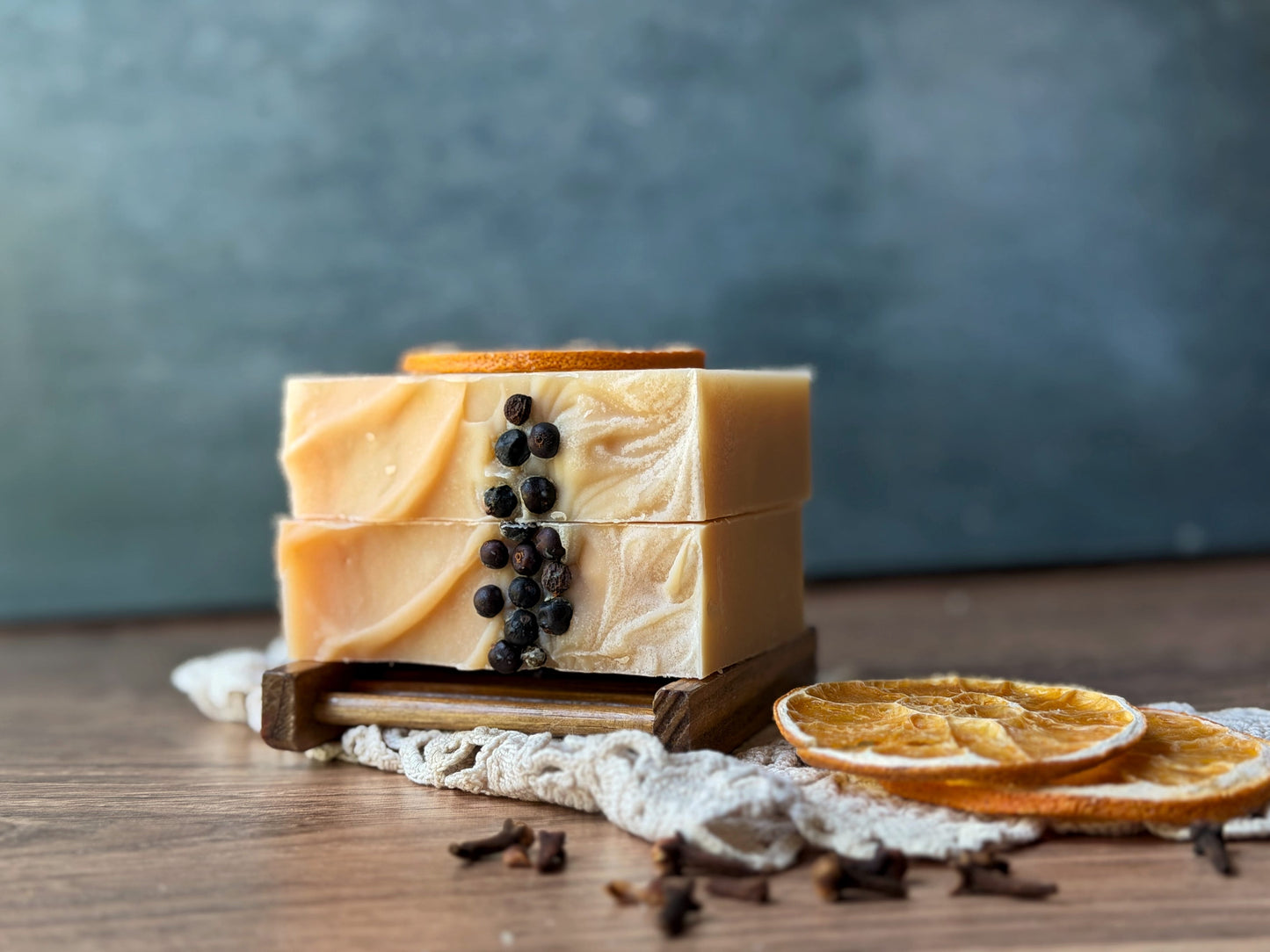 Three Lil Daisy Soaps Orange & Clove Goat Milk Soap bars evoke spicy citrus scents with dried orange and spices.
