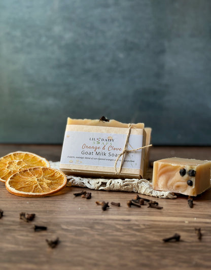 Lil Daisy Soaps’ Orange & Clove Goat Milk Soap bars with dried oranges and cloves for a rustic touch.