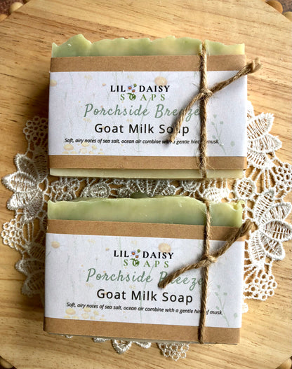Two Porchside Breeze Goat Milk Soaps from Lil Daisy Soaps, wrapped in paper and tied with twine.