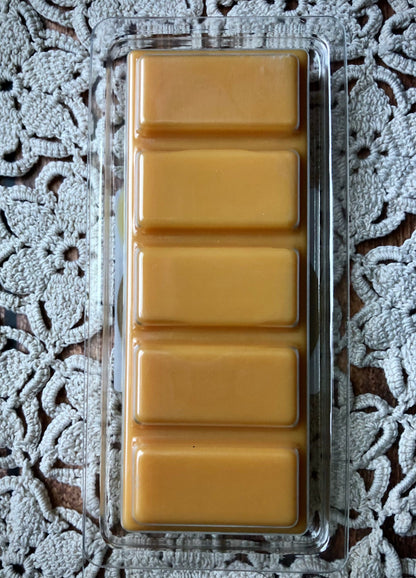 A plastic tray holds five Lil Daisy Soaps Pumpkin Caramel Crunch Snap Bar Wax Melts on cream lace.