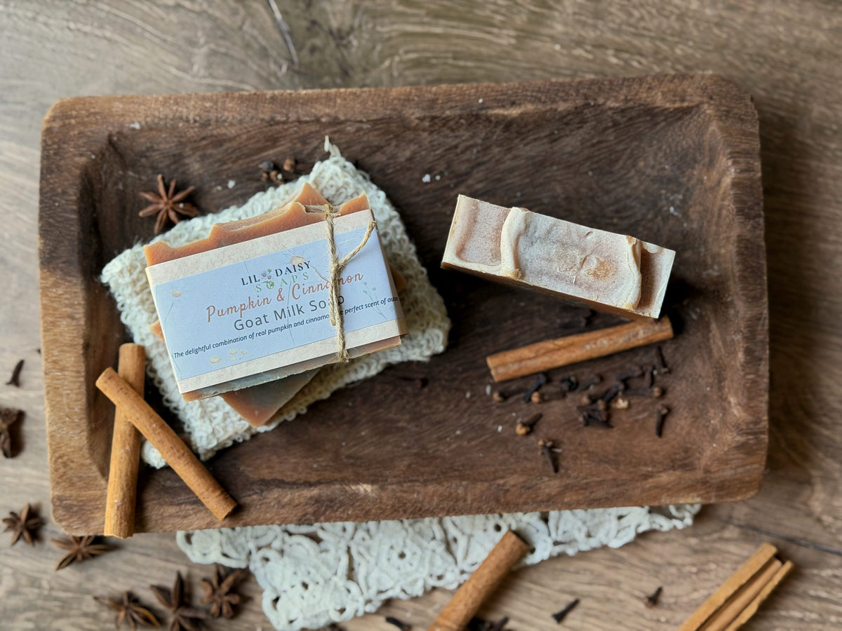 Lil Daisy Soaps Pumpkin Cinnamon Goat Milk Soap bars with skin-loving vitamins on a tray with spices.