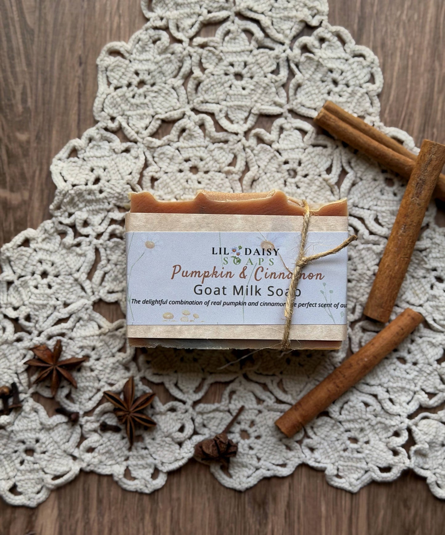 Lil Daisy Soaps Pumpkin Cinnamon Goat Milk Soap on a lace doily with cinnamon sticks and star anise.