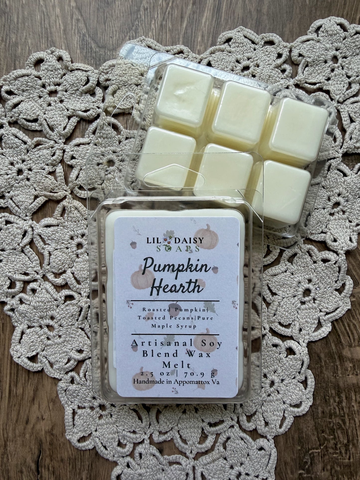 Two packs of Lil Daisy Soaps Pumpkin Hearth soy wax melts on lace doily; handmade in Virginia.