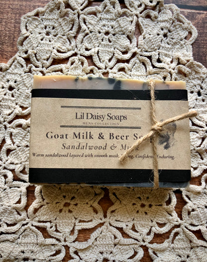 Bar of Lil Daisy Soaps Sandalwood & Musk Goat Milk & Beer Soap, creamy lather, wrapped in brown paper with twine.