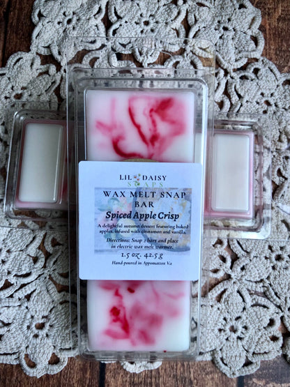 The Spiced Apple Crisp Snap Bar Wax Melt by Lil Daisy Soaps has red-white swirls and a cozy autumn dessert scent.