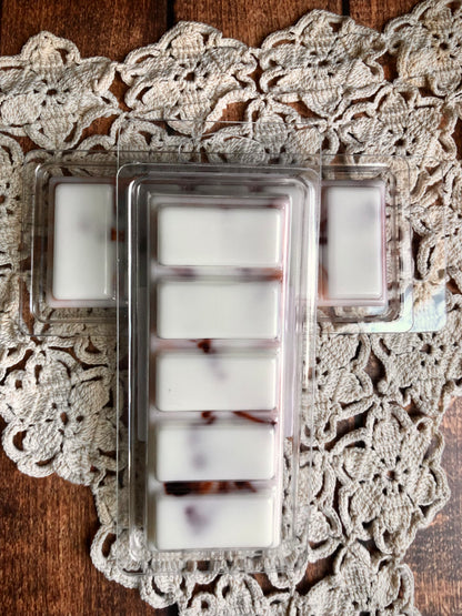 Lil Daisy Soaps Sugar & Spice Snap Bar Wax Melt with brown swirls, displayed on a lace doily for home fragrance.
