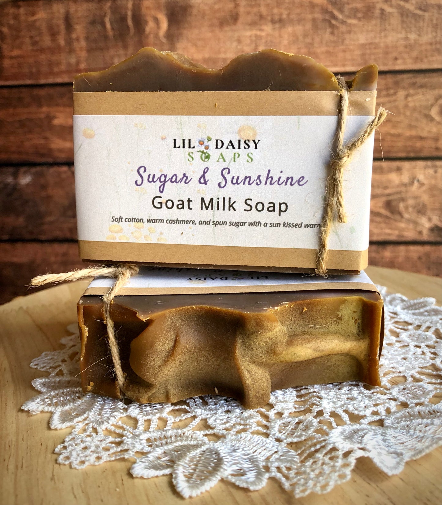 Two Lil Daisy Soaps Sugar & Sunshine goat milk bars displayed with rustic twine on a lace doily.