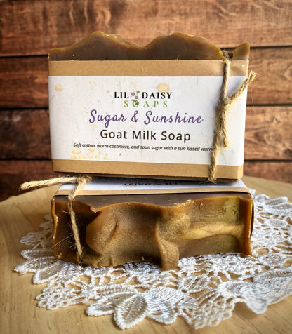 Two Lil Daisy Soaps Sugar & Sunshine goat milk bars displayed with rustic twine on a lace doily.
