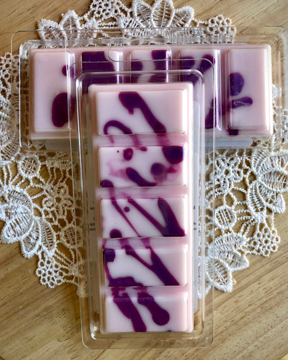 Sunlit Orchard Wax Melt Snap Bar by Lil Daisy Soaps: pink/purple swirls, green fruity scent, plastic-wrapped.