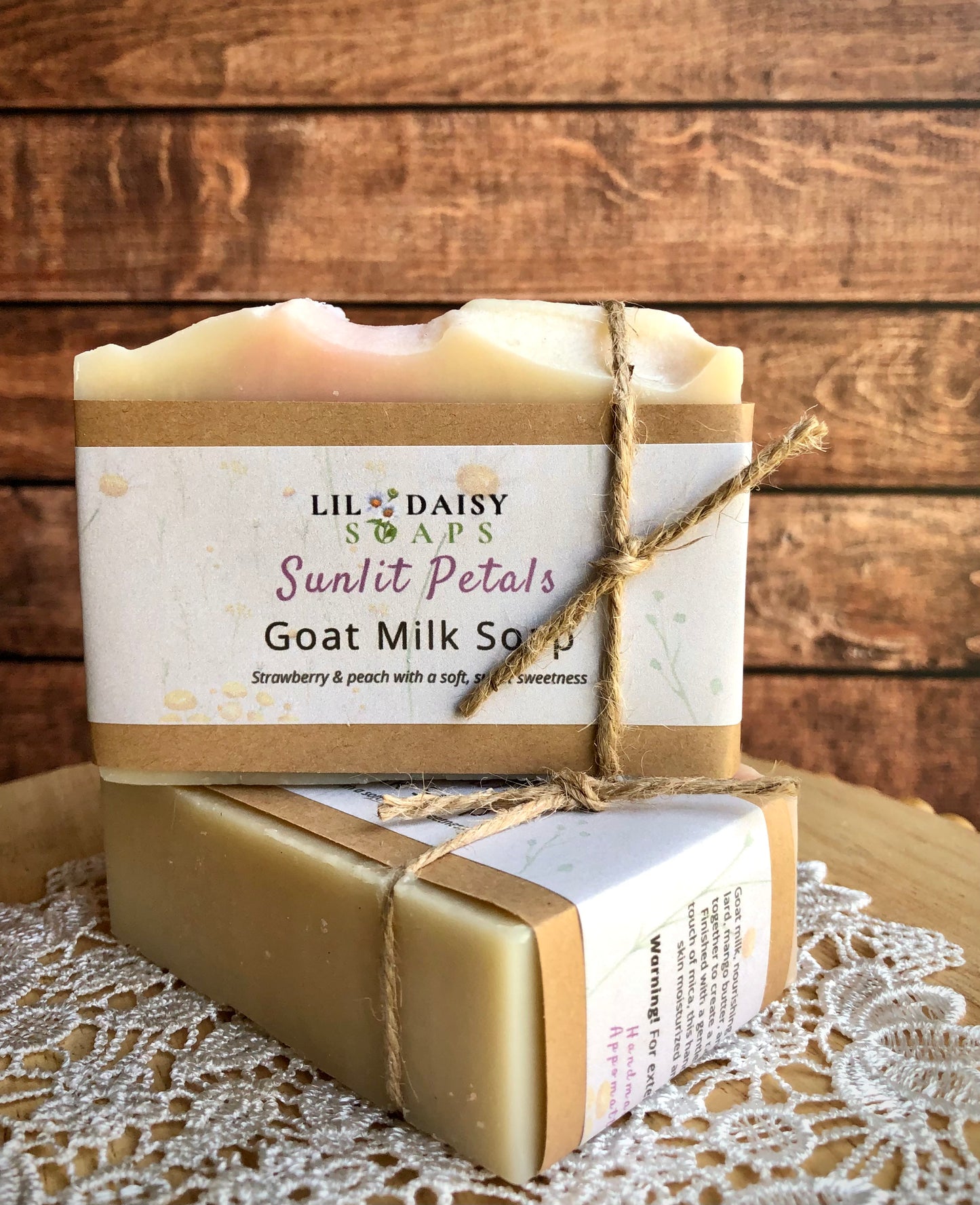 Two Sunlit Petals Goat Milk Soaps by Lil Daisy Soaps, handmade and wrapped in paper and twine.