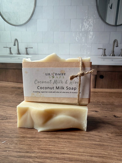 Two Lil Daisy Soaps Unscented Coconut Milk & Aloe Bars stacked on a counter—great for sensitive skin.